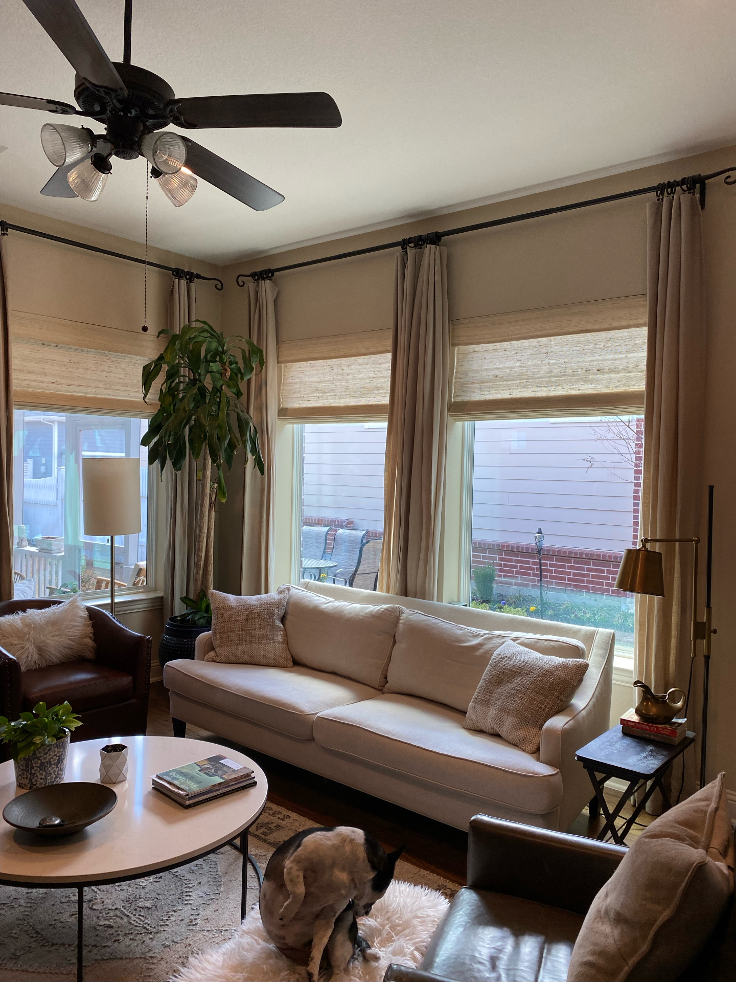 Living room with layered woven shades and drapery