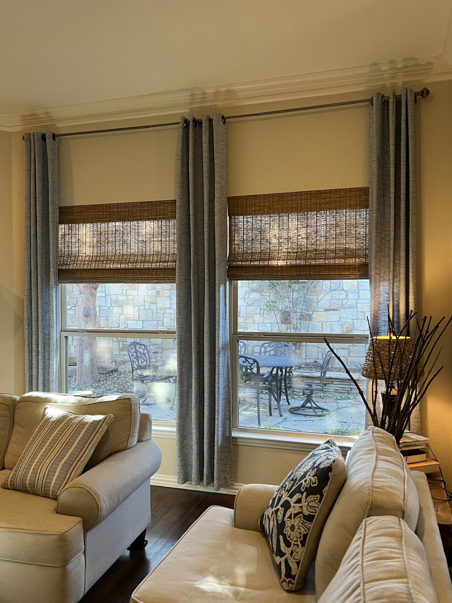 Master bedroom with layered drapery and roller shades