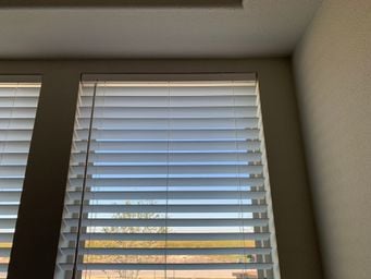 Faux wood blinds close-up at sunset